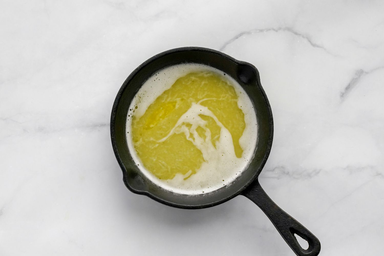 Garlic Ghee Mixture in a Small Cast Iron Skillet for Sabzi Polo Recipe