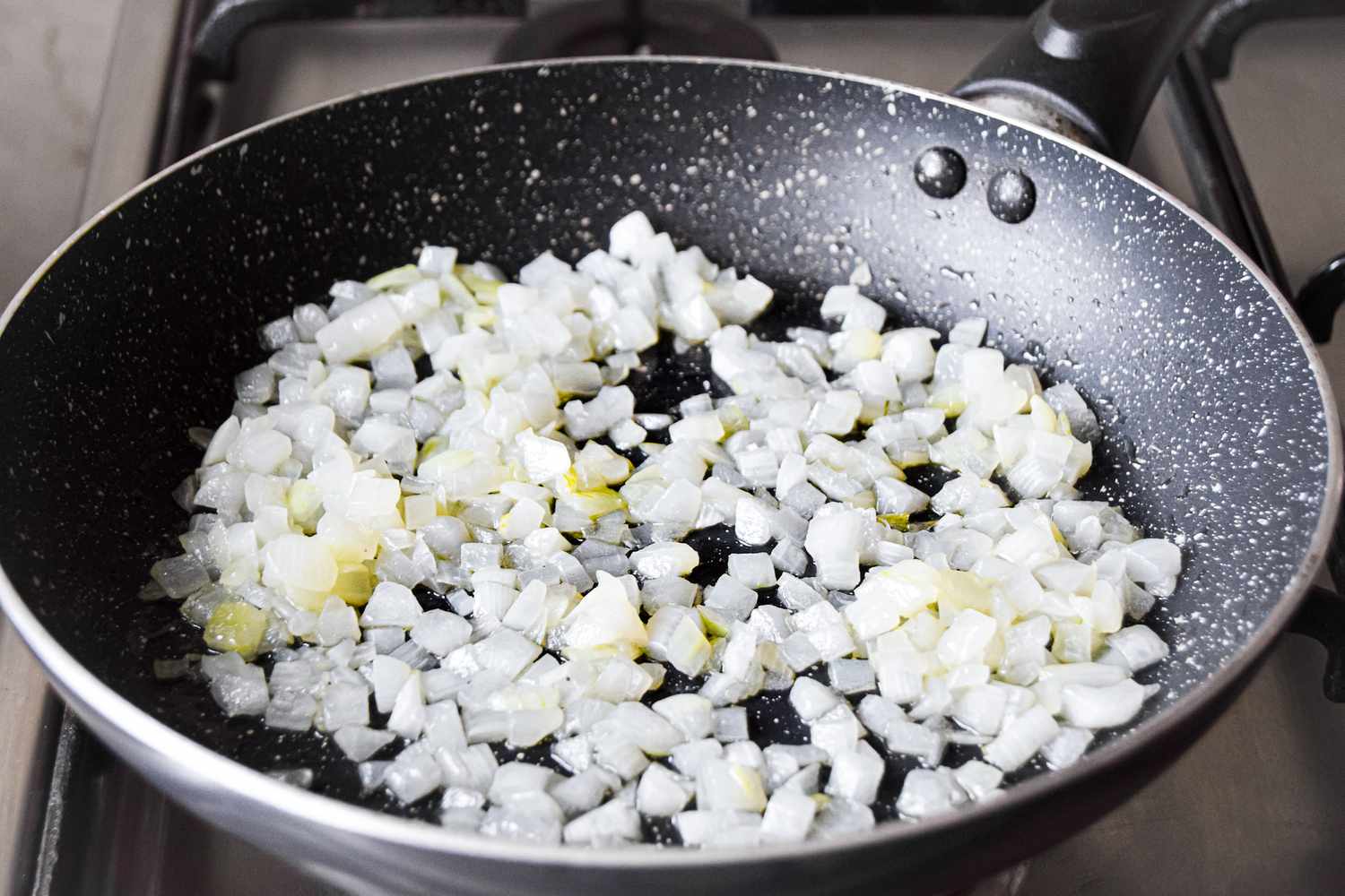 Onions and Garlic Sautéed in a Pan on the Stove for Easy Spinach Frittata