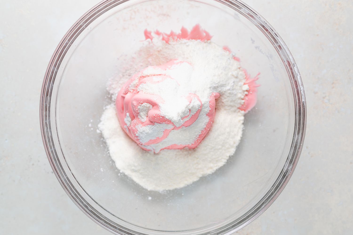 Stirring dry ingredients into meringue for macarons with raspberry filling