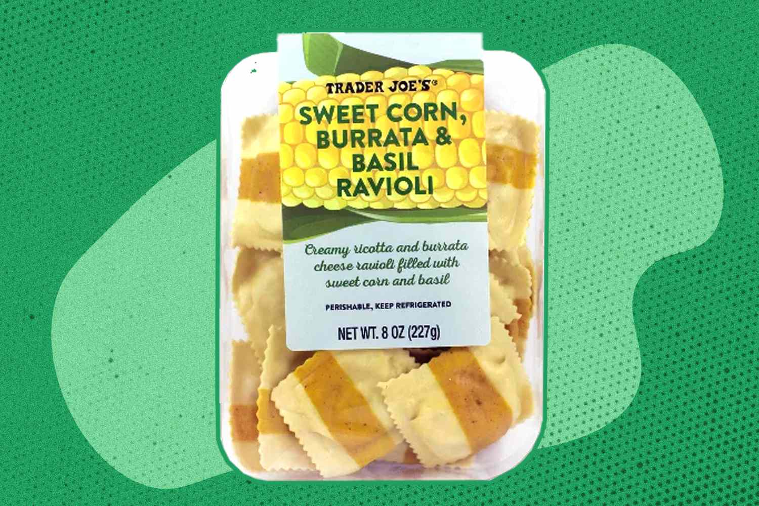 A packaged tray of Trader Joe's sweet corn, burrata, and basil ravioli on a green background