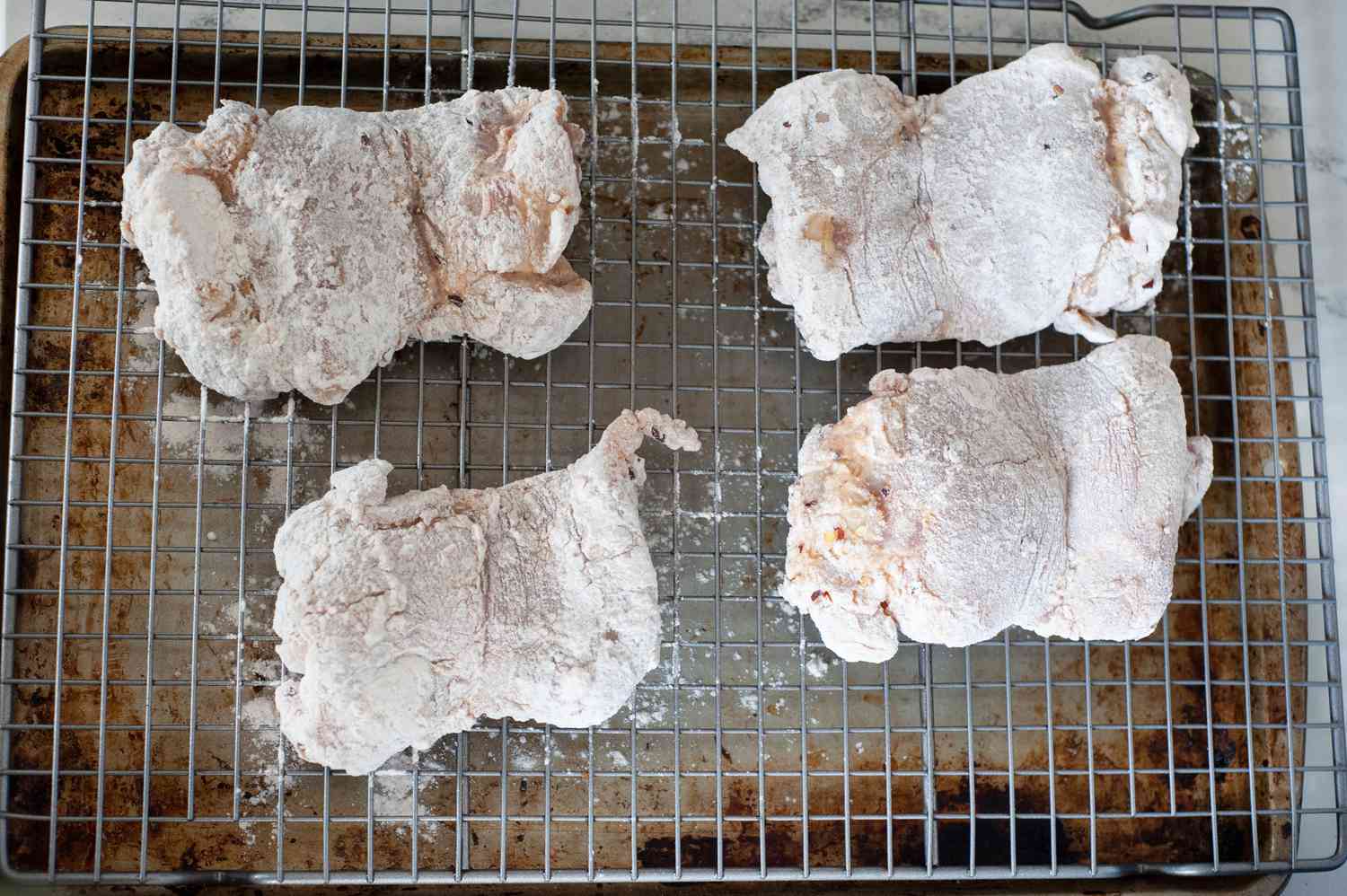 Fried chicken before being fried on a sheet pan