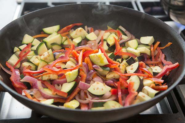 zucchini, peppers, and onion in skillet