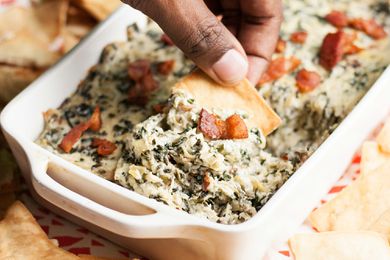 Easy Spinach Artichoke Dip with Bacon in a white casserole dish