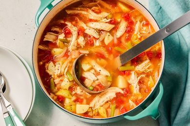 Chicken Vegetable Soup in a pot with a ladle