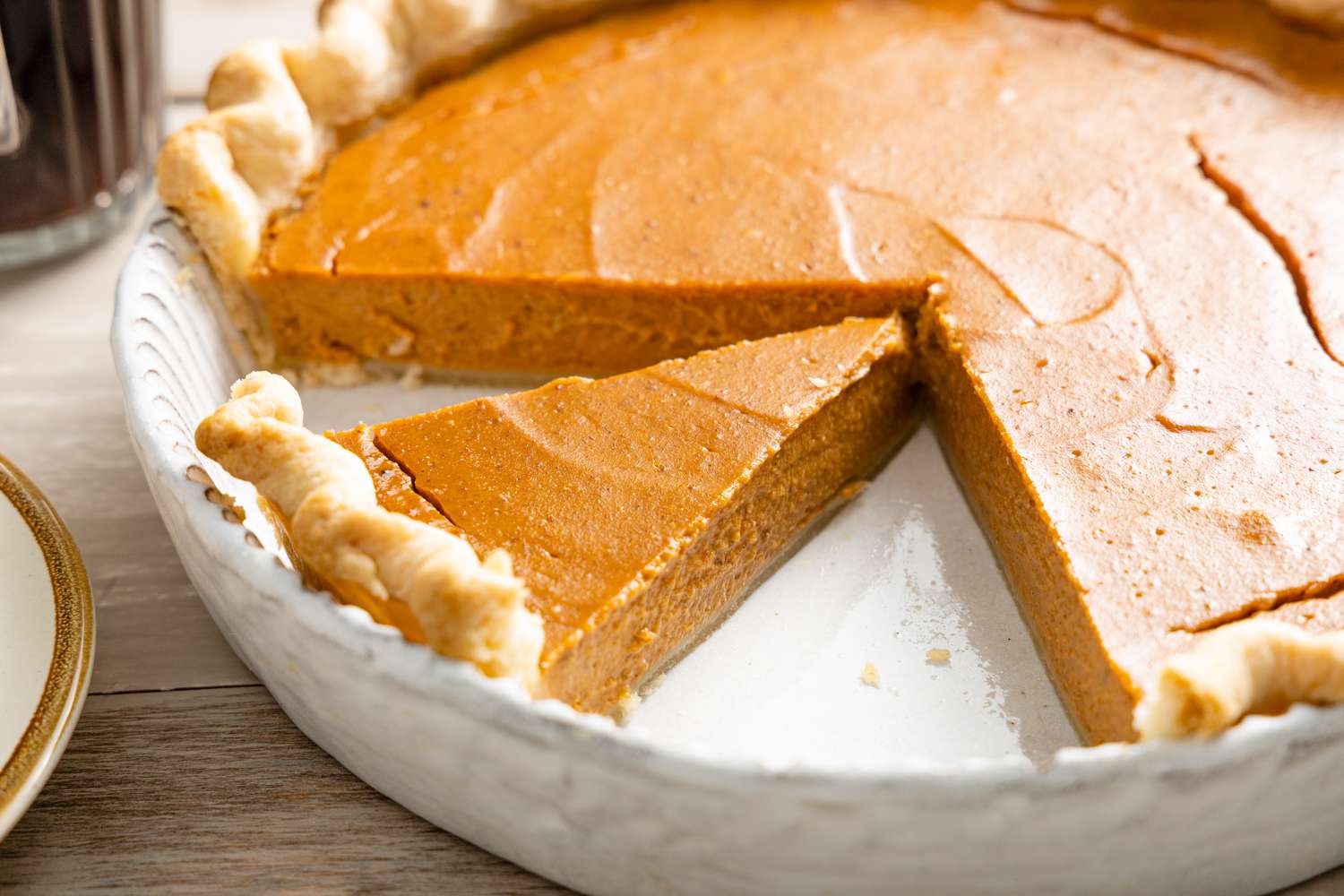 Vegan Pumpkin Pie in a Pie Dish with a Slice of Pie Cut Out