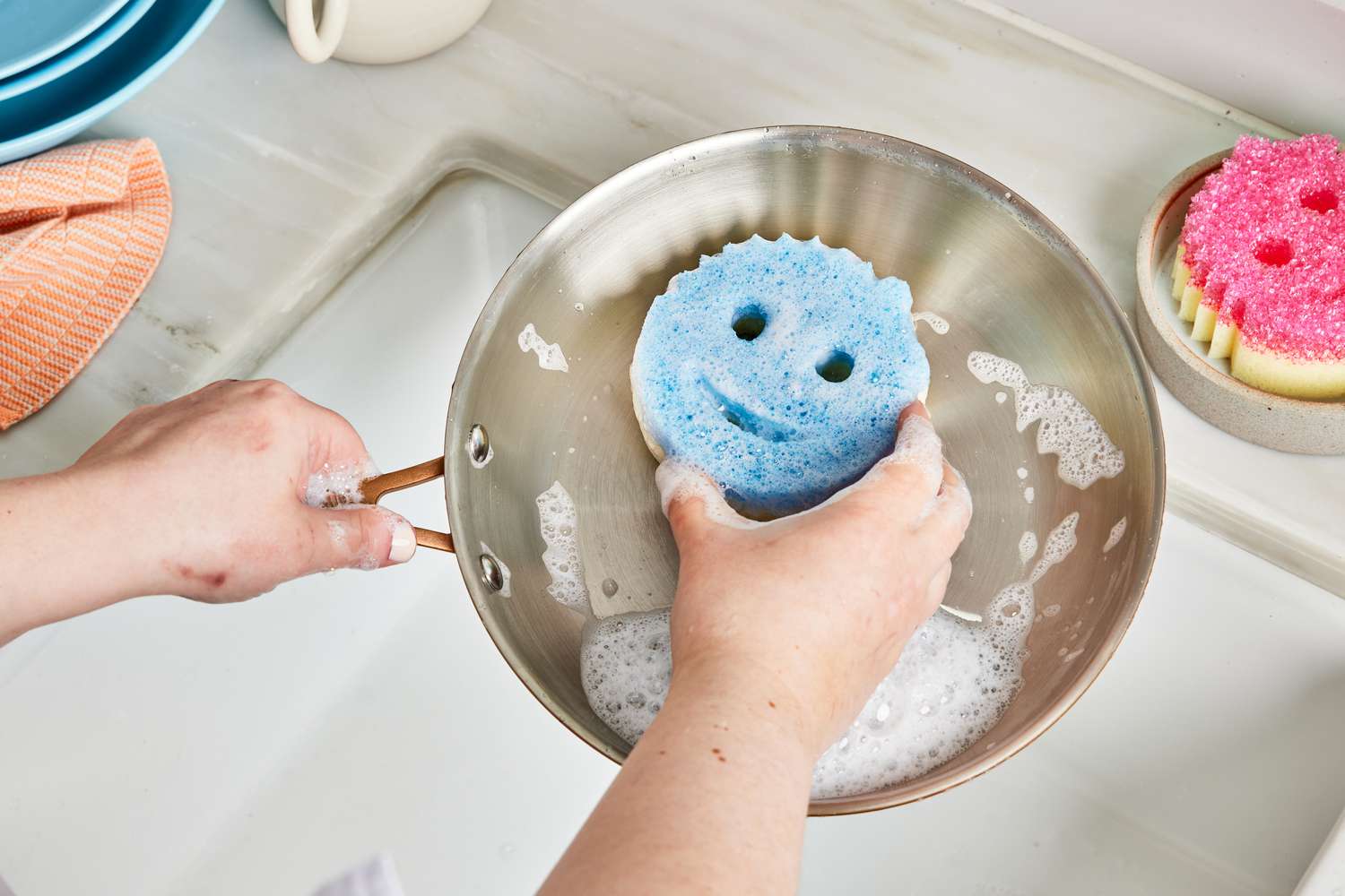 Scrub Daddy sponge on stainless steel pan