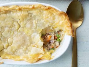 Leftover turkey pot pie in a large casserole dish with serving spoon