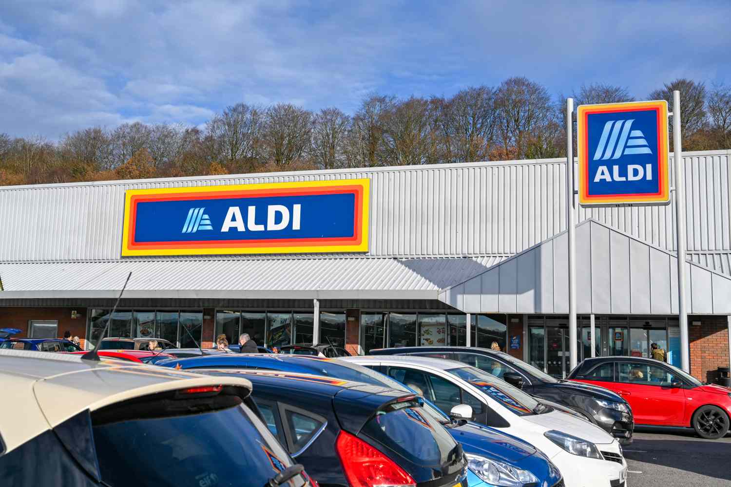 An Aldi supermarket storefront with a parking lot in the foreground
