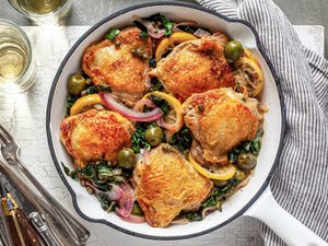 Sicilian chicken in skillet with olives, lemons, and capers.