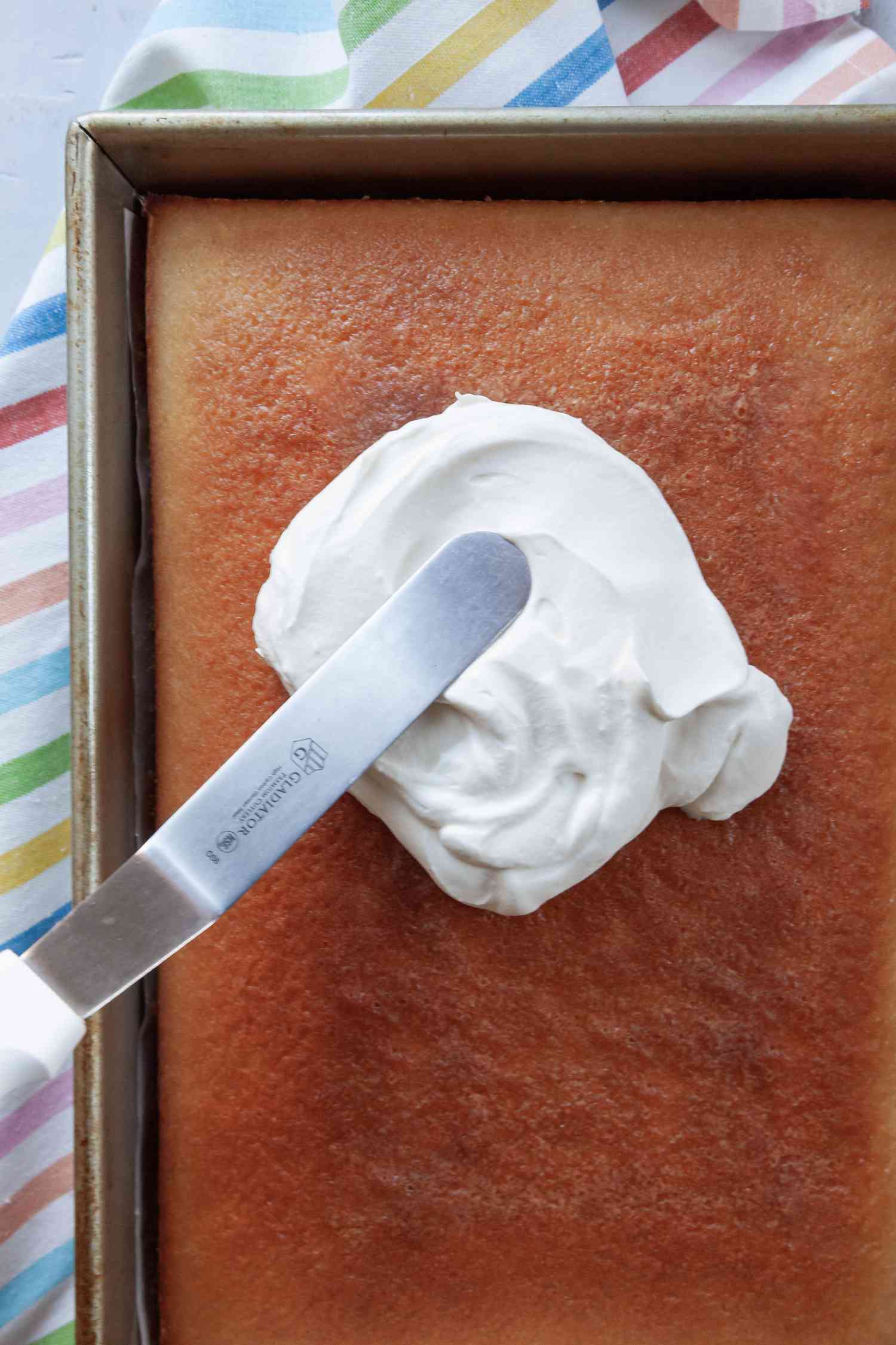 The best whipped cream frosting spread on a cake.