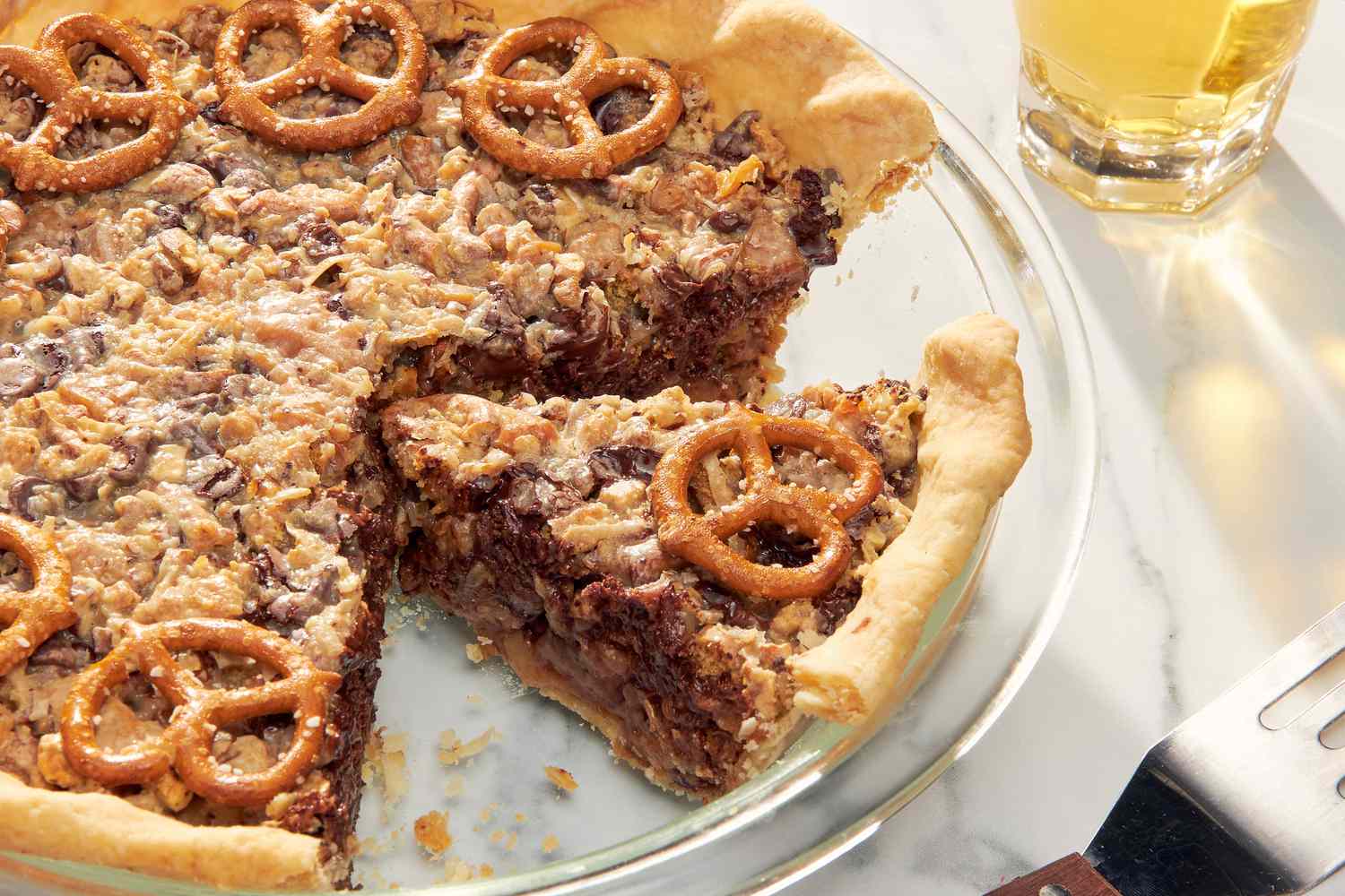 Texas trash pie in a pie dish with a slice cut out 