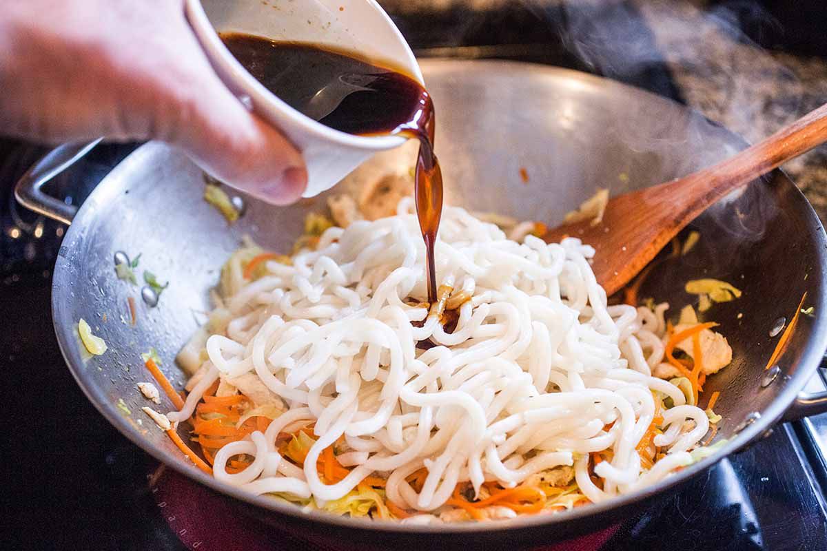 Homemade chicken lo mein add the noodles and sauce