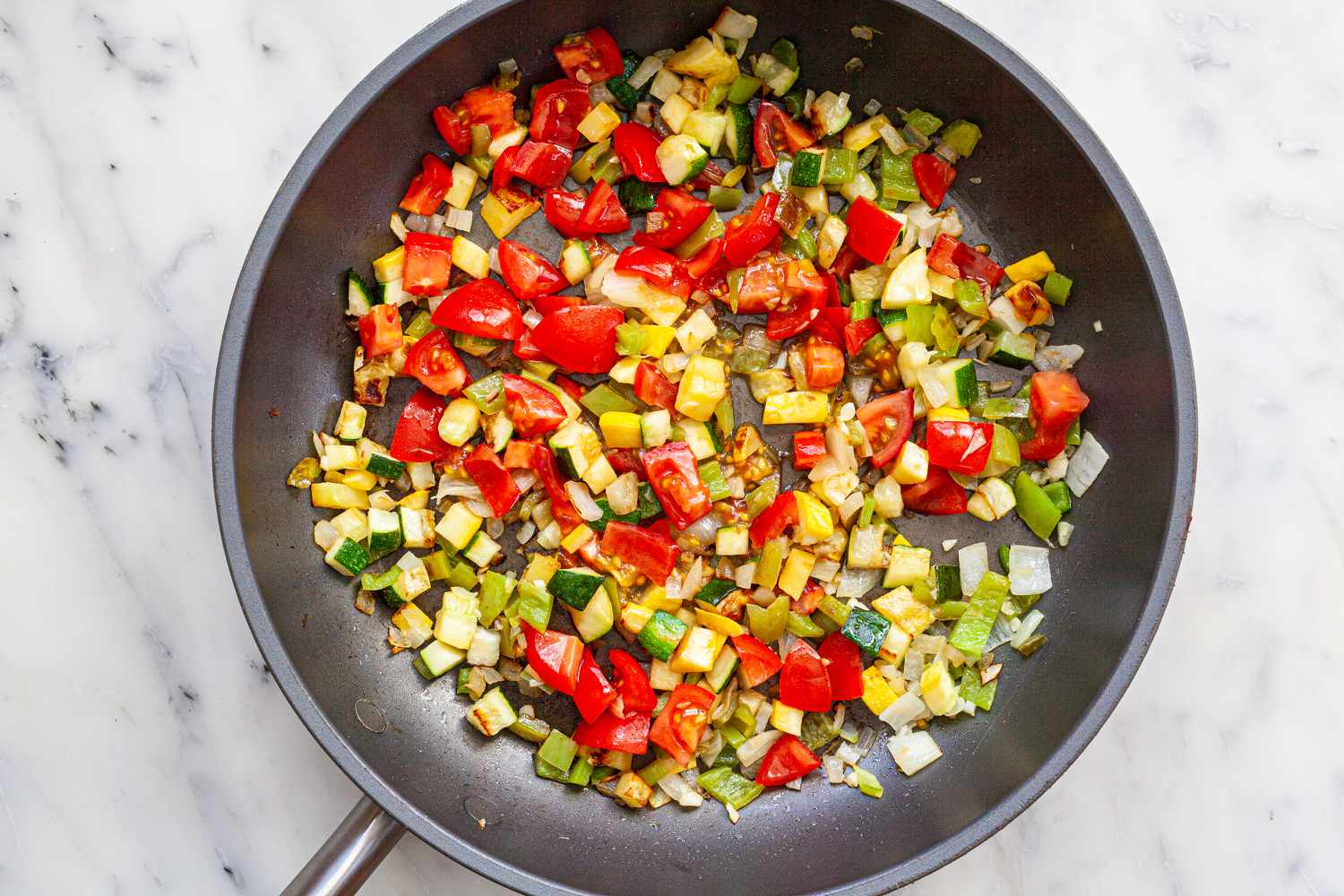 Diced vegetables in a skillet to show how to make tacos.