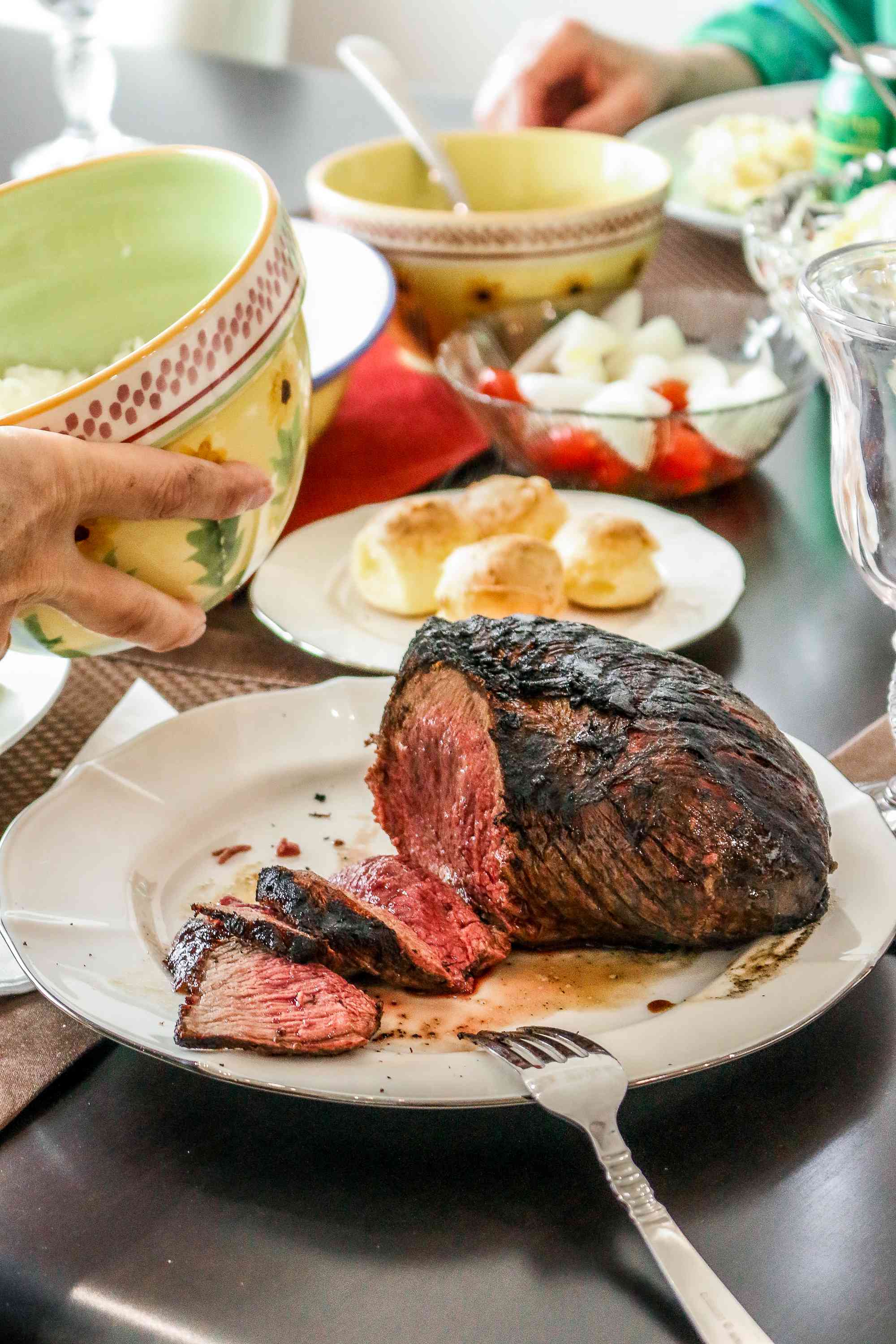 Grilled picanha, partially sliced on a platter