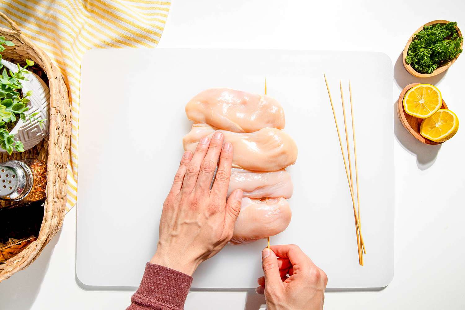 chicken breasts being skewered