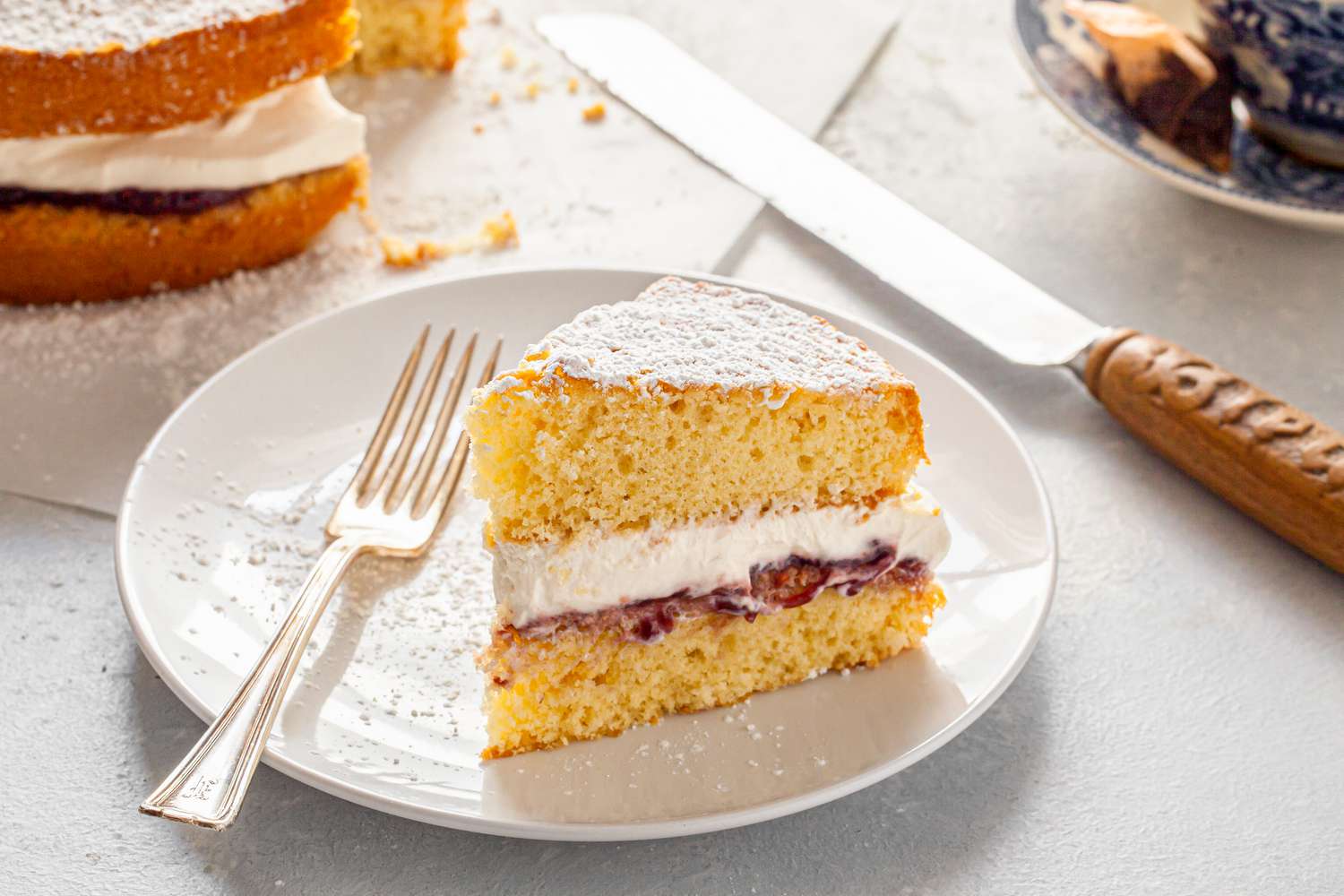 Slice of Victoria Sponge Cake on a Plate with a Fork