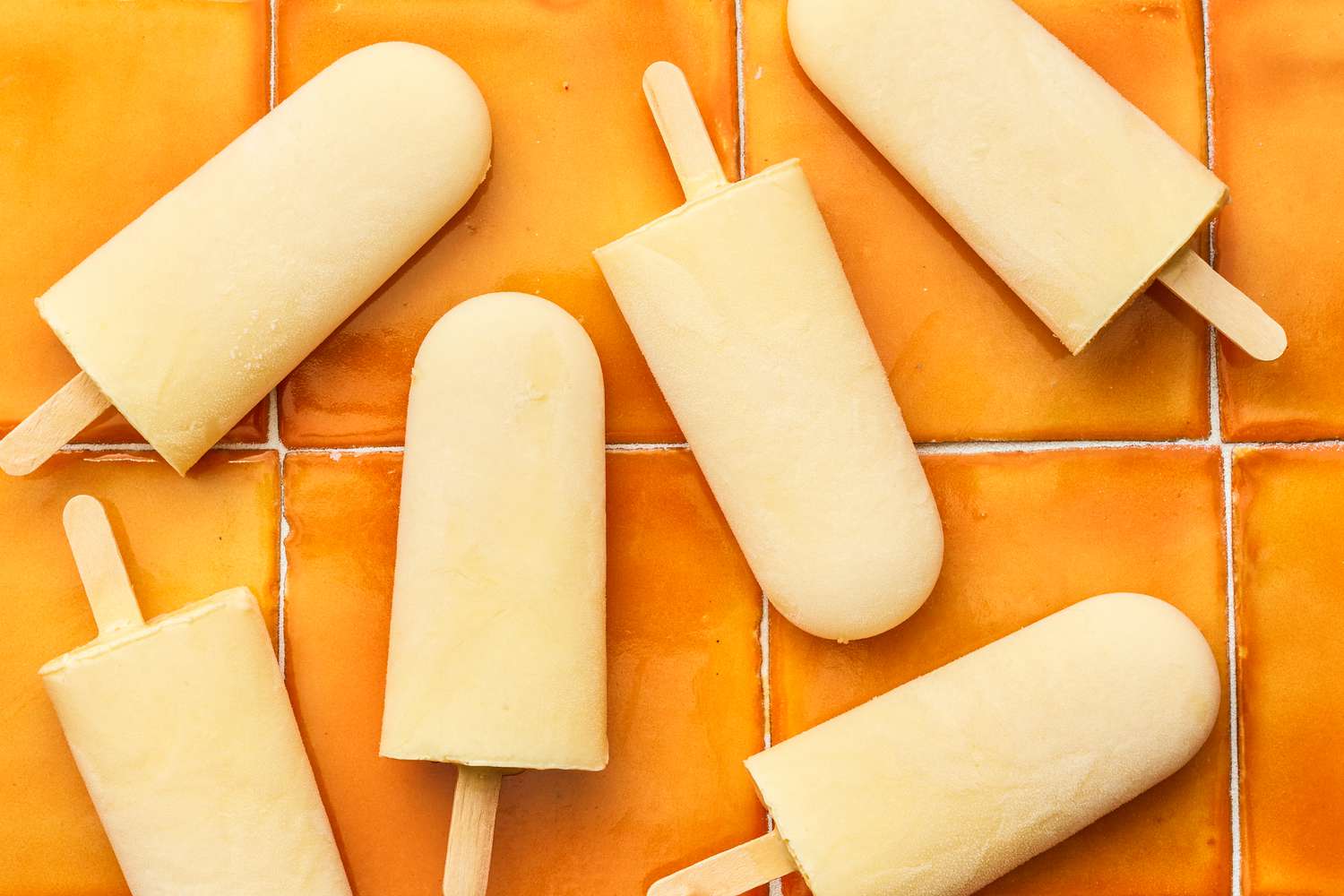 Orange Cream Popsicles on an Orange Tiled Surface