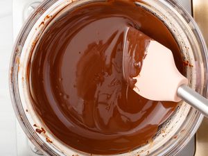 Overhead view of a glass bowl of melted chocolate.