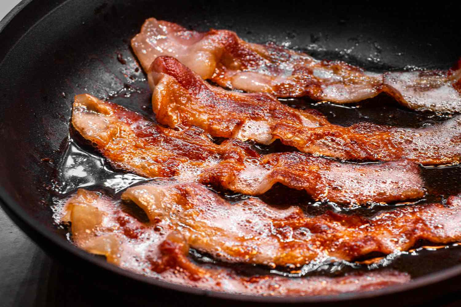 Bacon frying in a pan