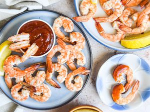 Shrimp Cocktail on a plate with cocktail sauce and lemons
