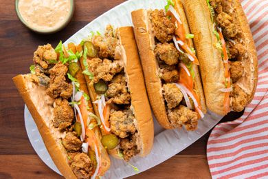 A Platter Filled with Oyster Po' Boys, Surrounded by a Kitchen Towel and a Bowl of Remoulade 