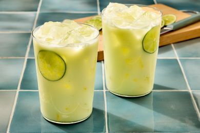Two glasses of limonada on a tiled surface