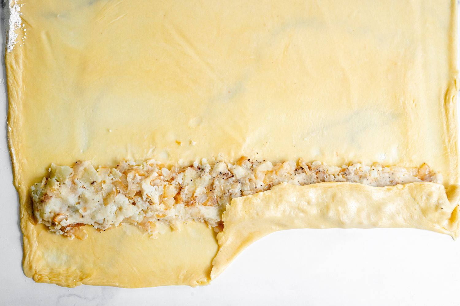 Potato Mixture with Knish Dough Folded Over It