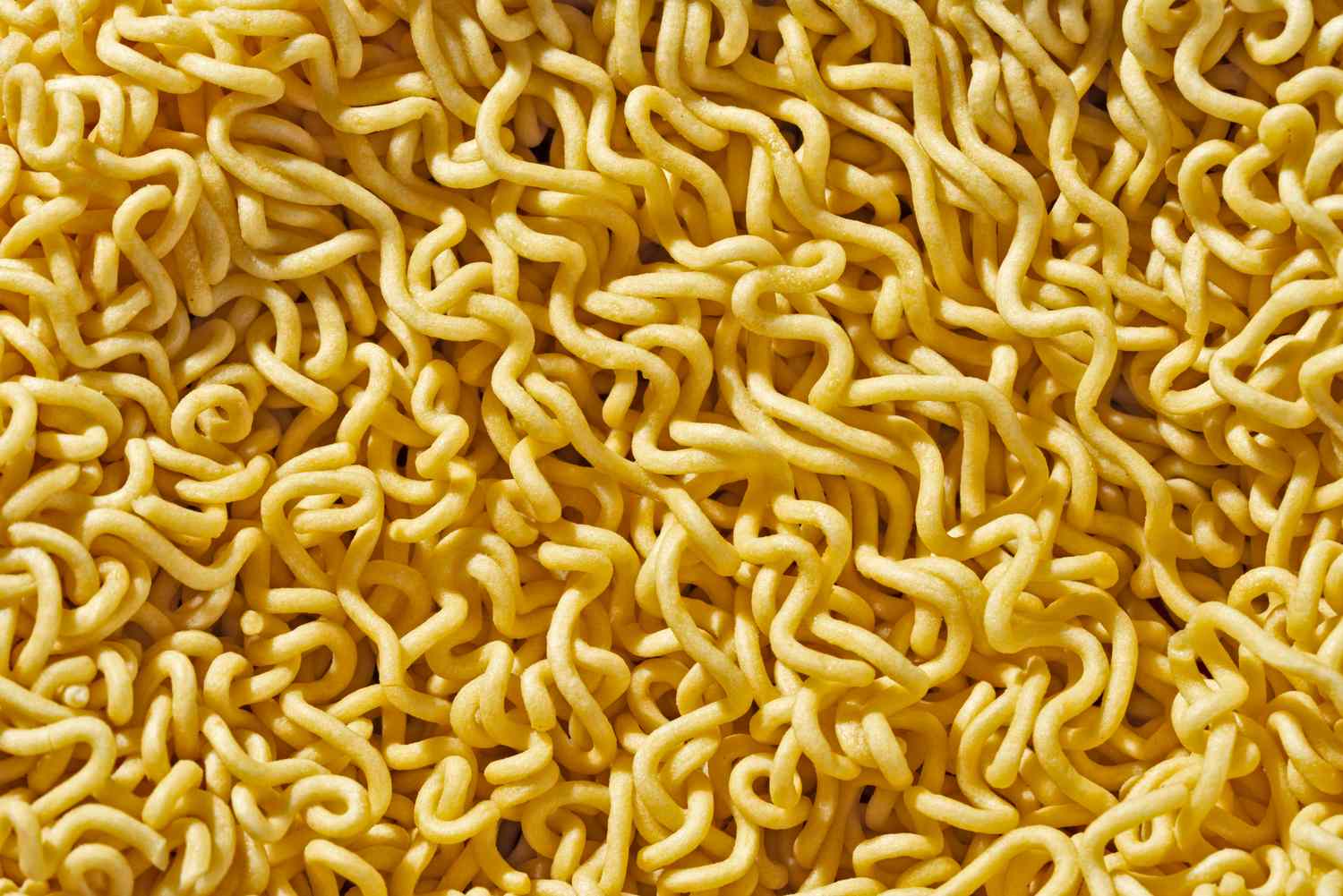 Dry ramen noodles in a closeup view showing their texture