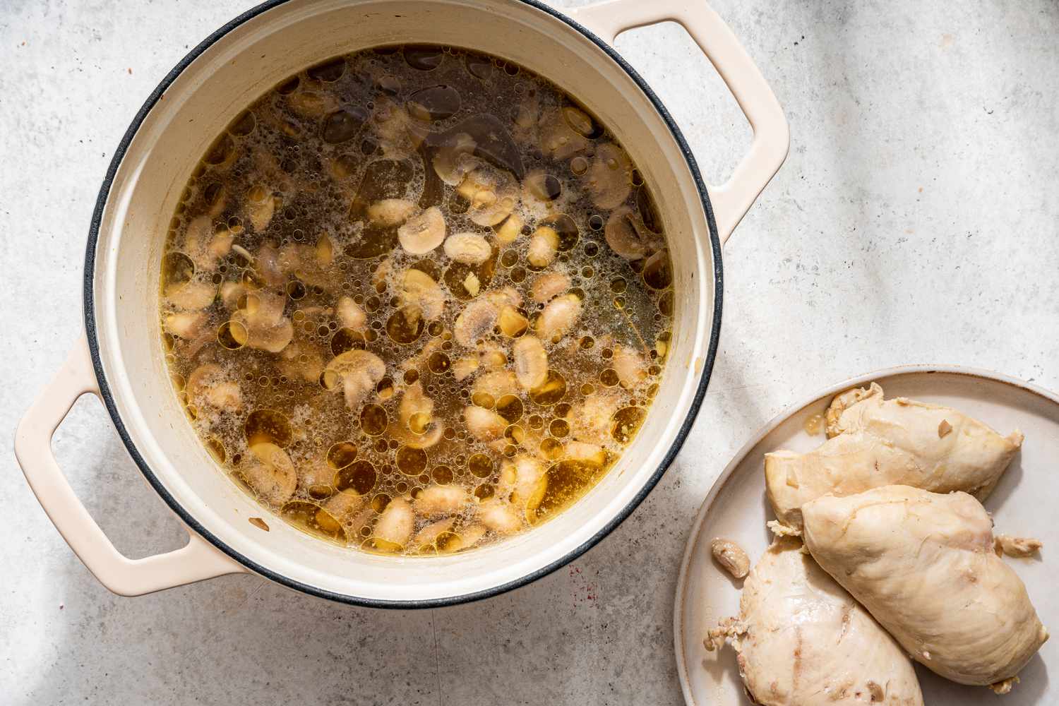 Chicken removed from the dutch oven and placed on a plate for white chicken lasagna soup recipe