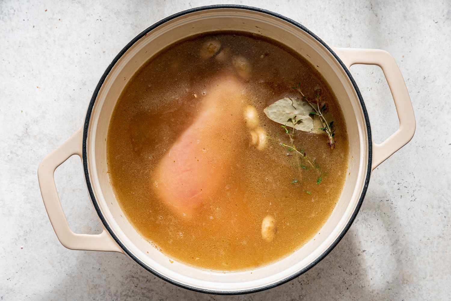 broth, herbs, and chicken added to pot with cooked mushrooms for white chicken lasagna soup recipe