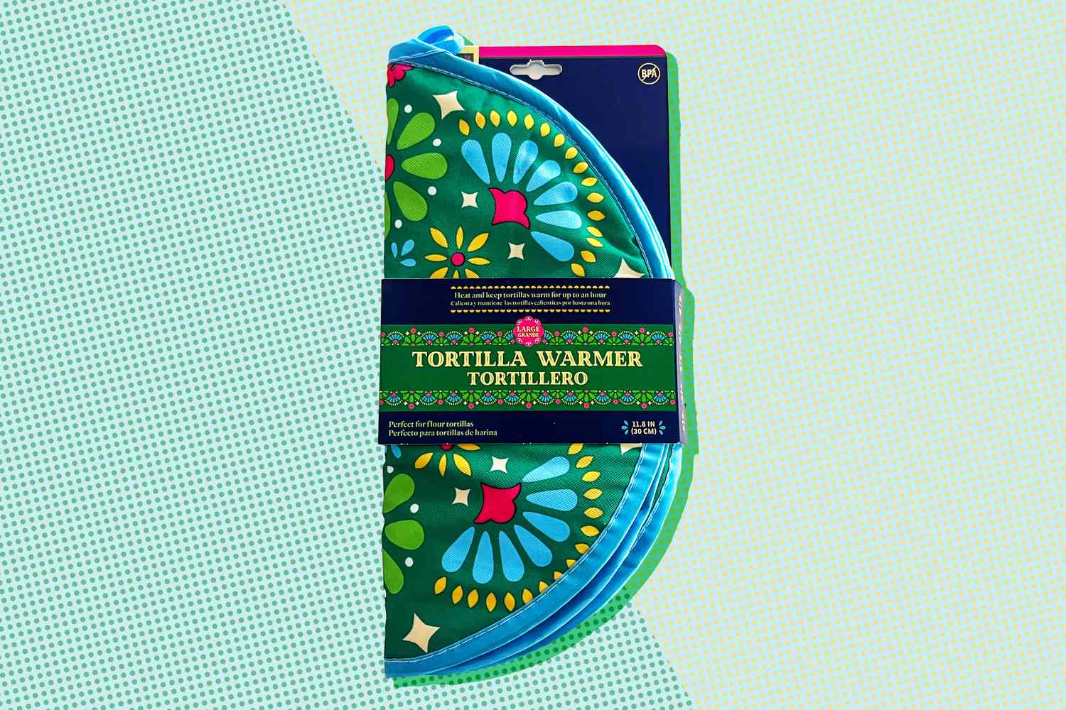 A floral-patterned tortilla warmer packaged in plastic