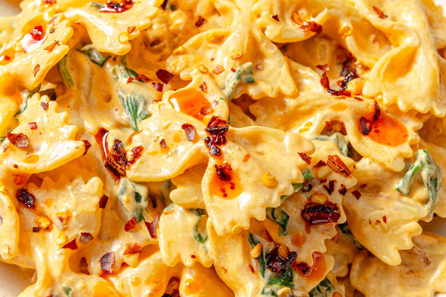Farfalle pasta in a creamy sauce with chili crisp and herbs
