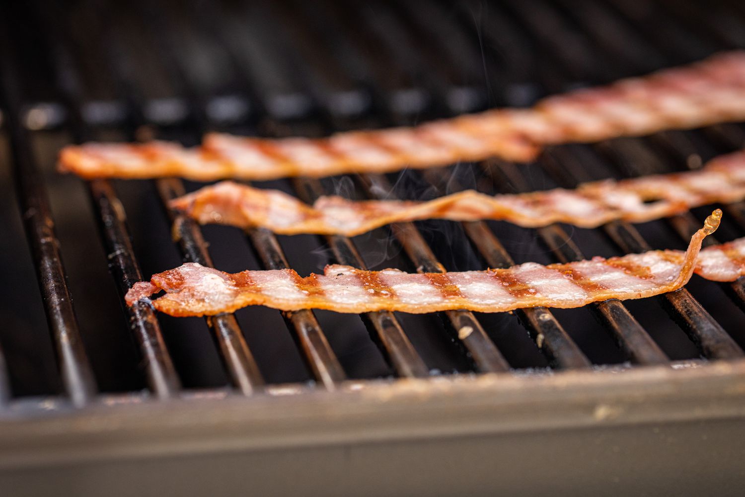 Bacon on a grill for the best bacon cheeseburger