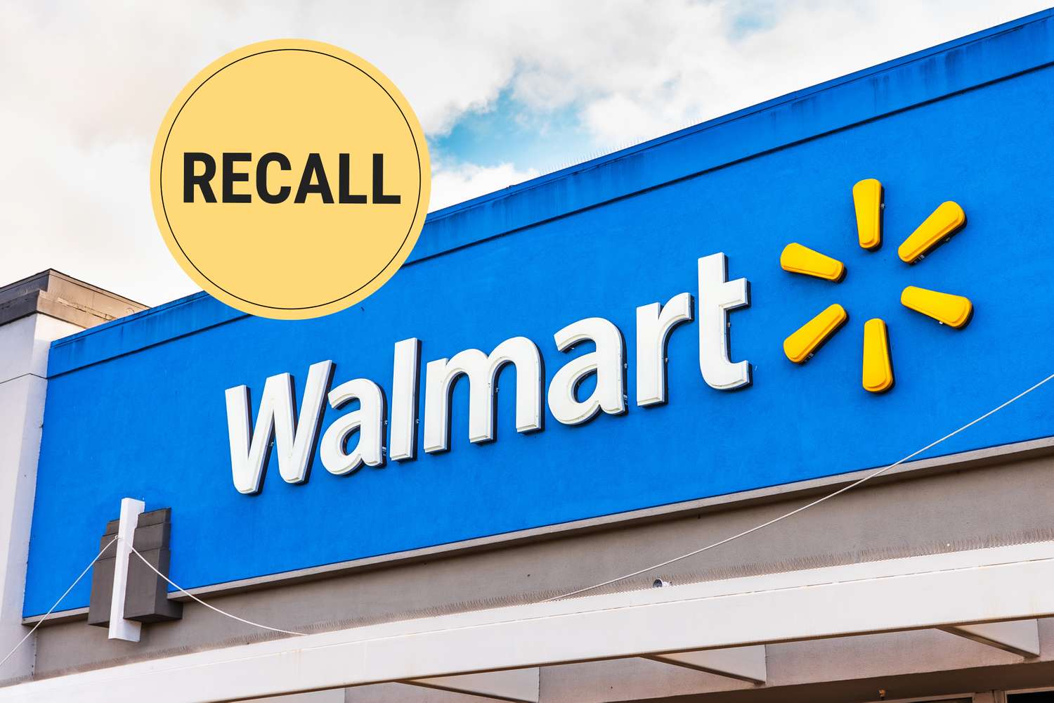 Walmart logo on storefront with a circular recall symbol in the corner