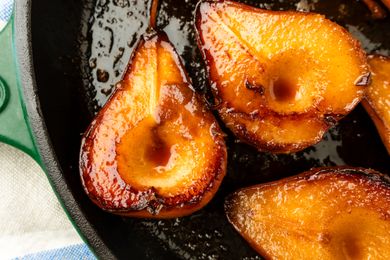 Caramelized pear halves in a skillet