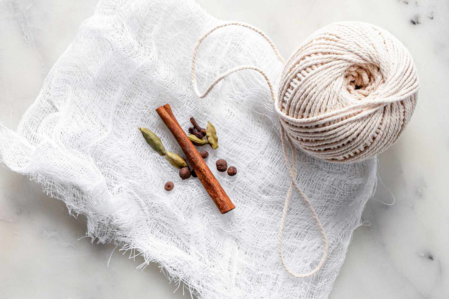 Cheesecloth and Kitchen Twine with Stick of Cinnamon, Allspice Berries, Cardamom Pods, and Cloves 
