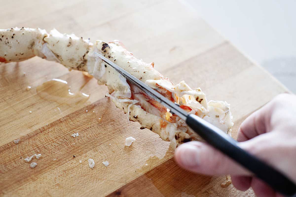 Using scissors for a crab leg recipe.