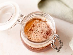 A small glass jar of brown butter sauce.