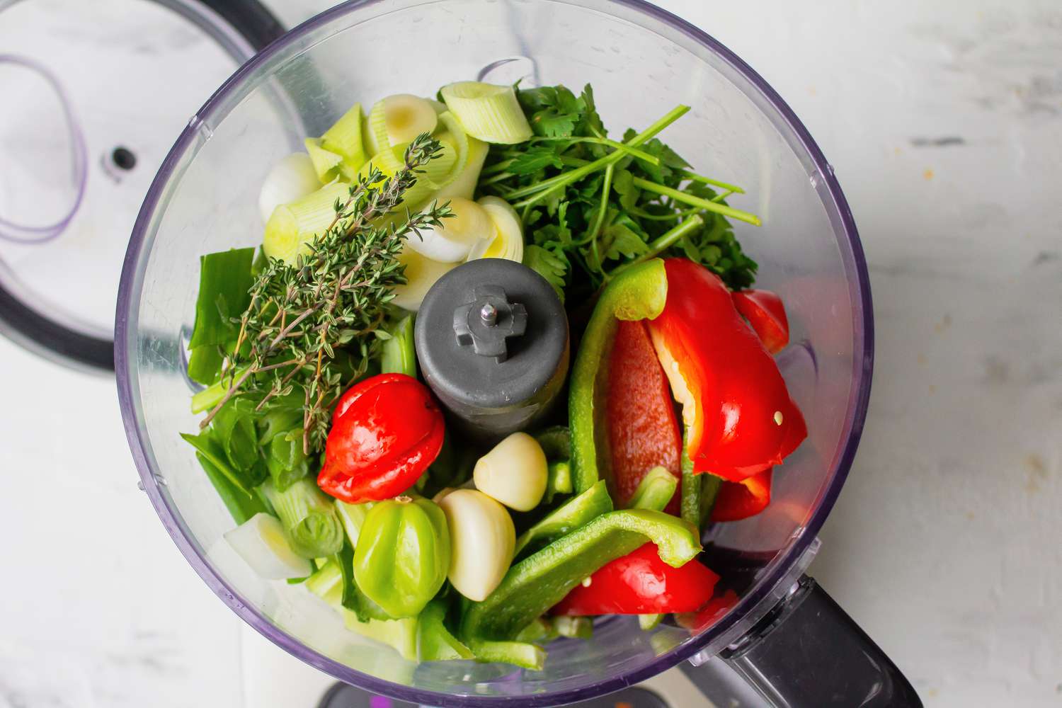 Onion, bell peppers, celery, and leeks in food processor for Haitian epis recipe
