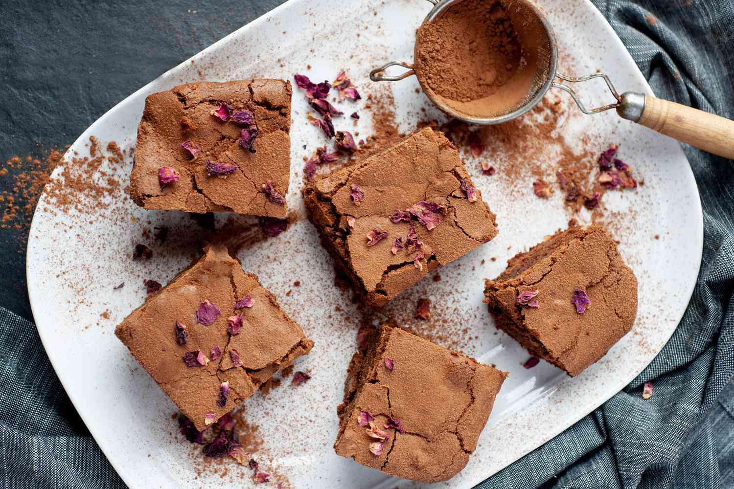 Spiced brownies dusted with cocoa powder.