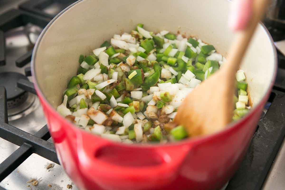 Stir the peppers, onions, and celery for shrimp gumbo into the roux