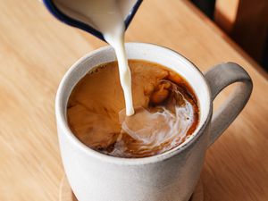 Creamers poured into a cup of coffee