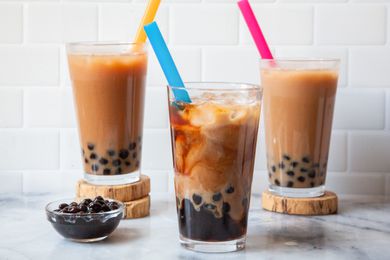 Three Glasses of Bubble Tea Next to a Bowl of Boba