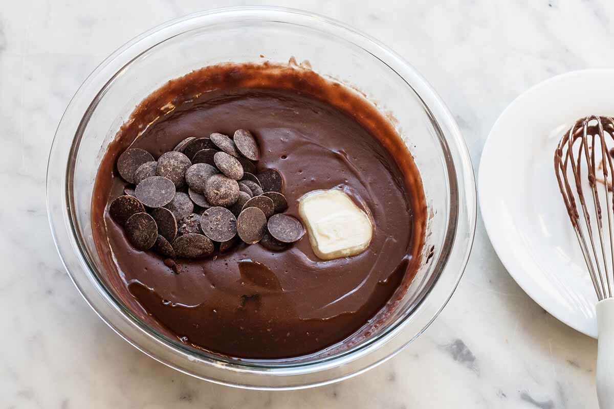 Filling for Chocolate Pudding Pie with chocolate chips and butter being added to it.