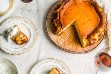 Basque-style cheesecake with slices cut out of it.