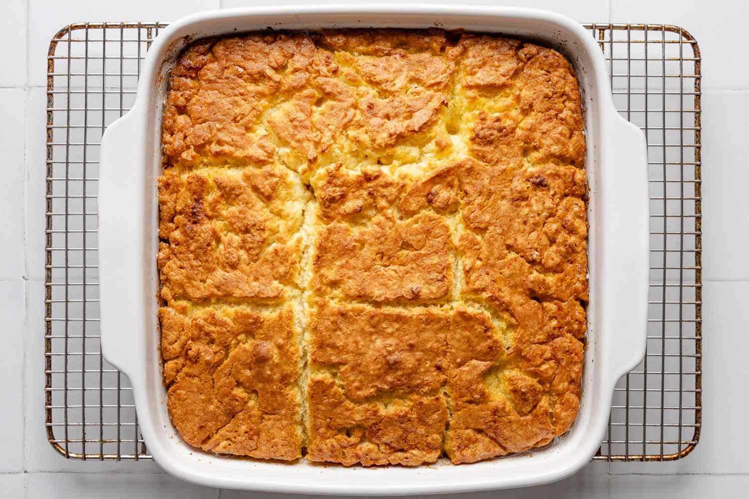 baking dish with butter swim biscuits cooling on a wire rack