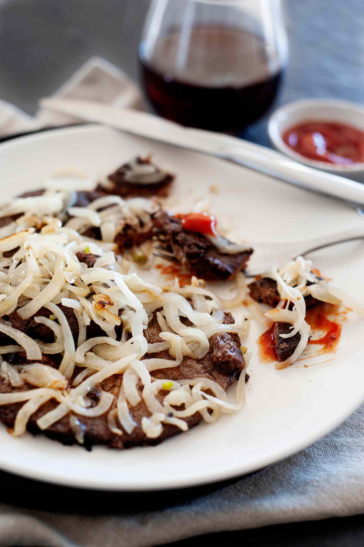 Side view of a plate with liver and onions recipe.