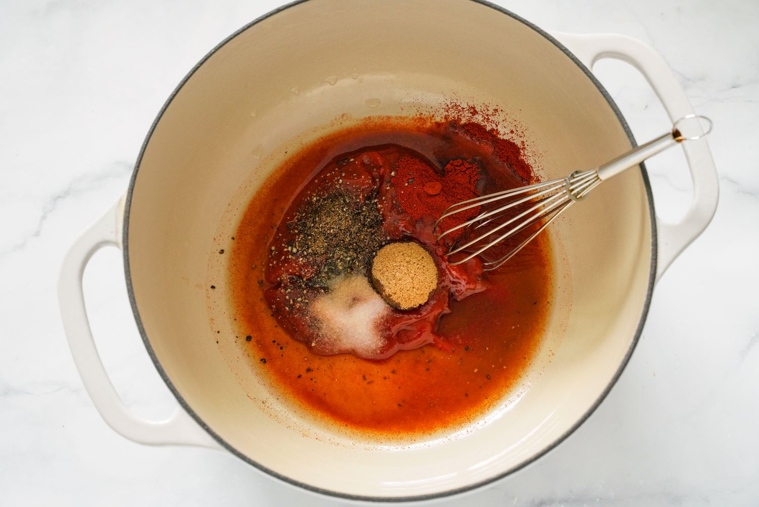 BBQ Spices in a Dutch Oven With a Whisk for Pulled Chicken Recipe