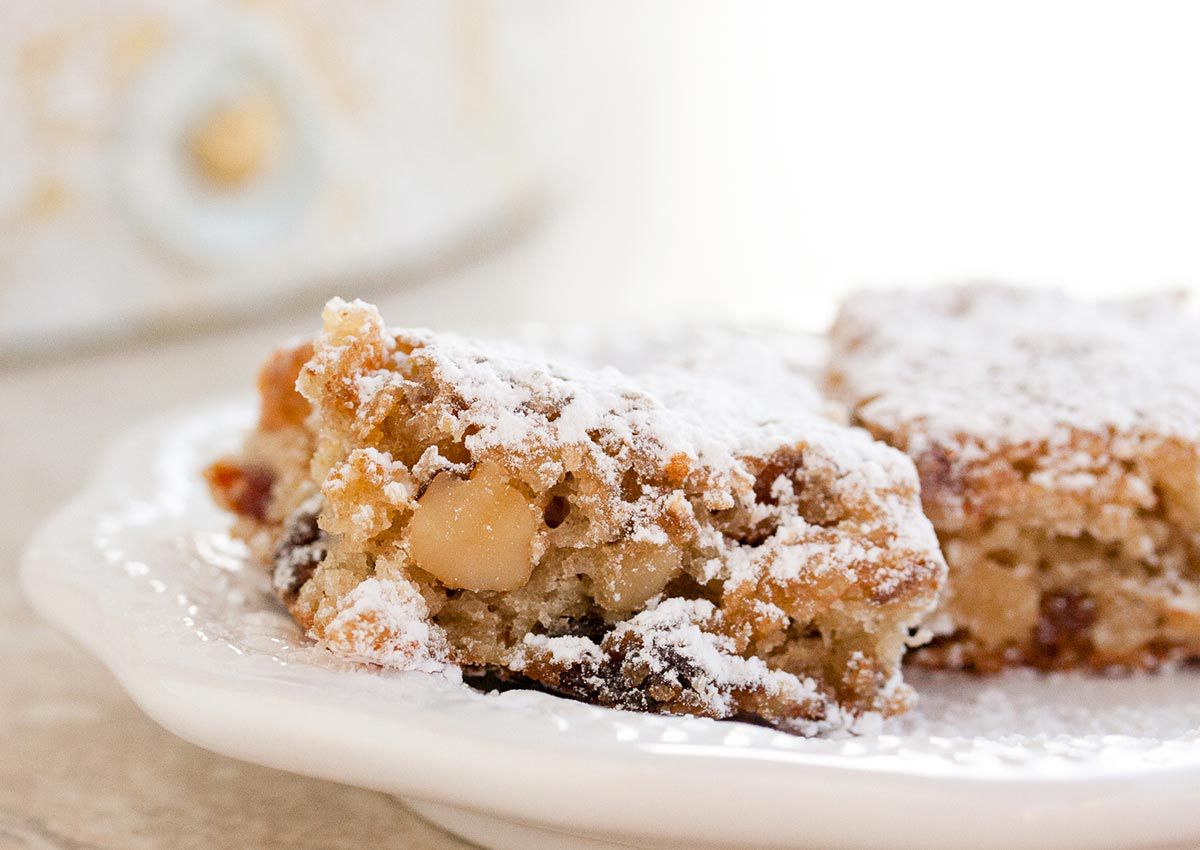 A plate with date-nut chews garnished with powdered sugar