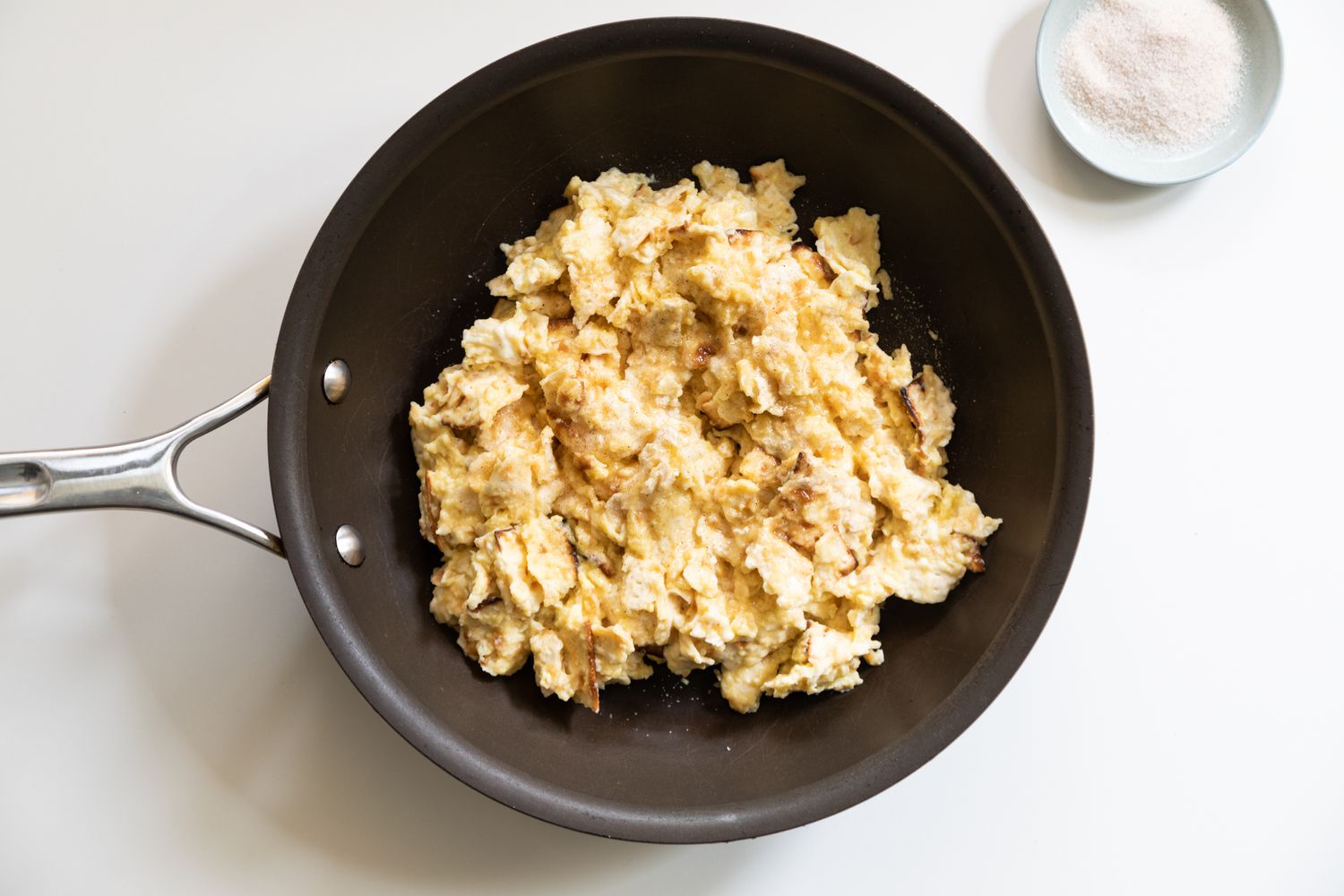 A skillet with matzah brei cooking inside.
